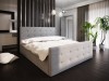 Modernes graues Doppelbett mit Knopfsteppung, Ansicht von rechts im Schlafzimmer.