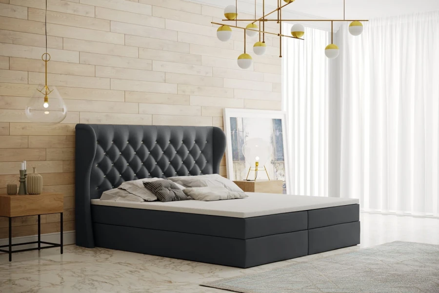 Modernes graues Boxspringbett mit gestepptem Kopfteil in stilvollem Schlafzimmer Ambiente.