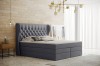 Graues Boxspringbett in modernem Schlafzimmer mit Holzoptik-Wand