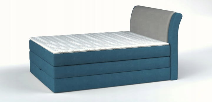 Stilvolles blaues Einzel-Boxspringbett schräg von vorne gesehen.
