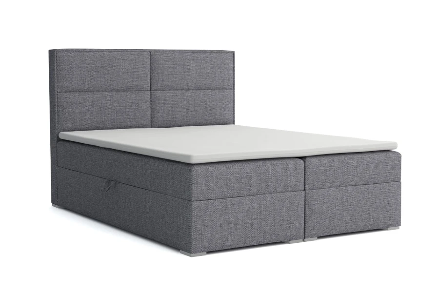 Dunkelgraues Boxspringbett mit schlichtem Kopfteil und weißem Topper vor weißem Hintergrund.