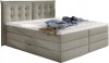 Modernes Boxspringbett in Beige mit gestepptem Kopfteil.