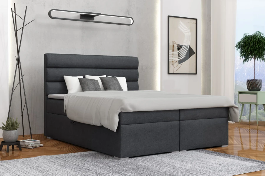 Dunkelgraues Boxspringbett mit horizontal gestepptem Kopfteil in modernem Schlafzimmer.
