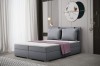 Graues Polsterbett inklusive großer Kissen und lila Decke in modernem Zimmer.