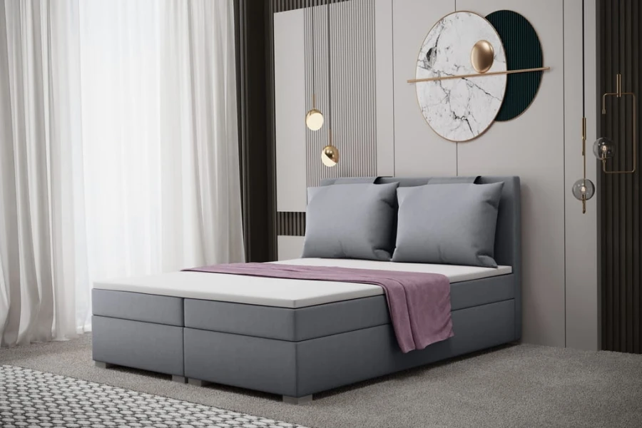 Graues Polsterbett inklusive großer Kissen und lila Decke in modernem Zimmer.