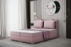 Elegantes rosa Boxspringbett mit passenden Kissen in einem stilvoll eingerichteten Schlafzimmer.