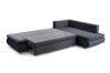 Zum Bett umgebautes graues Ecksofa, große Liegefläche für Gäste.