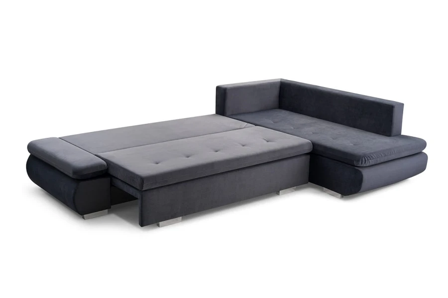Zum Bett umgebautes graues Ecksofa, große Liegefläche für Gäste.