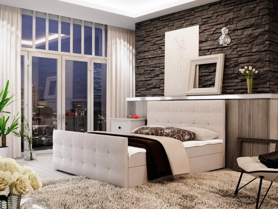 Hellgraues Boxspringbett mit gestepptem Kopf- und Fußteil in einem modernen Schlafzimmer.