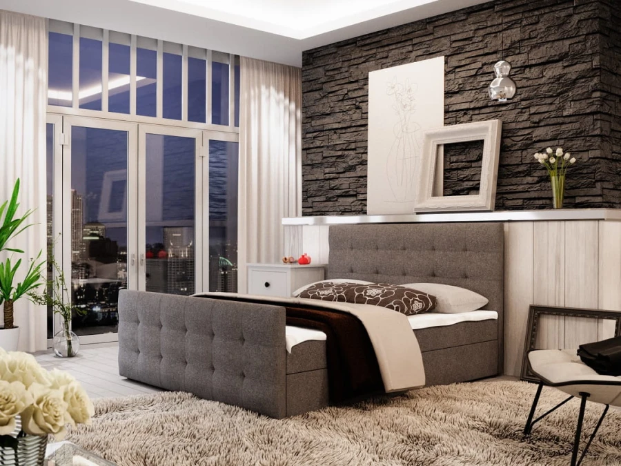 Modernes graues Boxspringbett mit Polsterung in einem hellen, stilvollen Zimmer.
