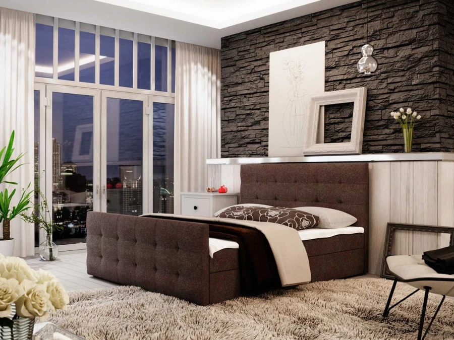 Braunes Boxspringbett mit eleganter Steppung in gemütlicher Schlafzimmer-Atmosphäre.
