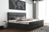 Modernes Schlafzimmer mit grauem Polsterbett, Kissen und dekorativem Wandbild.