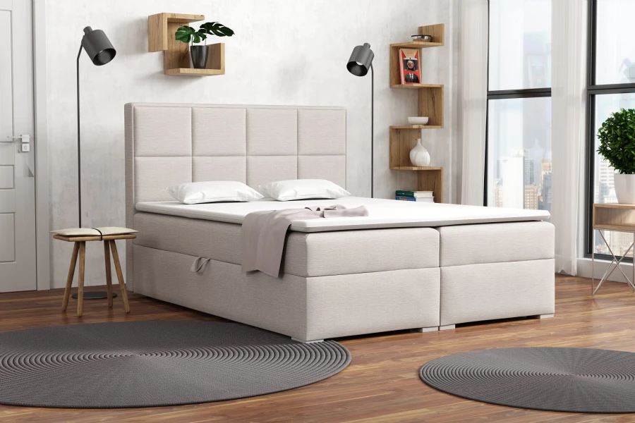 Beiges Boxspringbett in modern eingerichtetem Schlafzimmer.