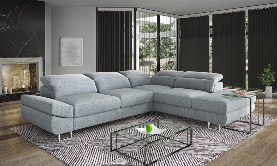 Großes graues Ecksofa in modernem Wohnzimmer mit Glas-Couchtisch und dunklen Rollos.
