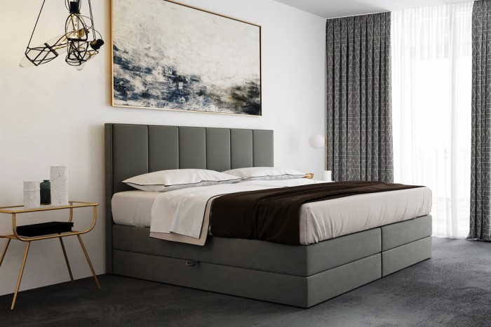 Gepolstertes Boxspringbett in Grau im modernen Schlafzimmer-Design.