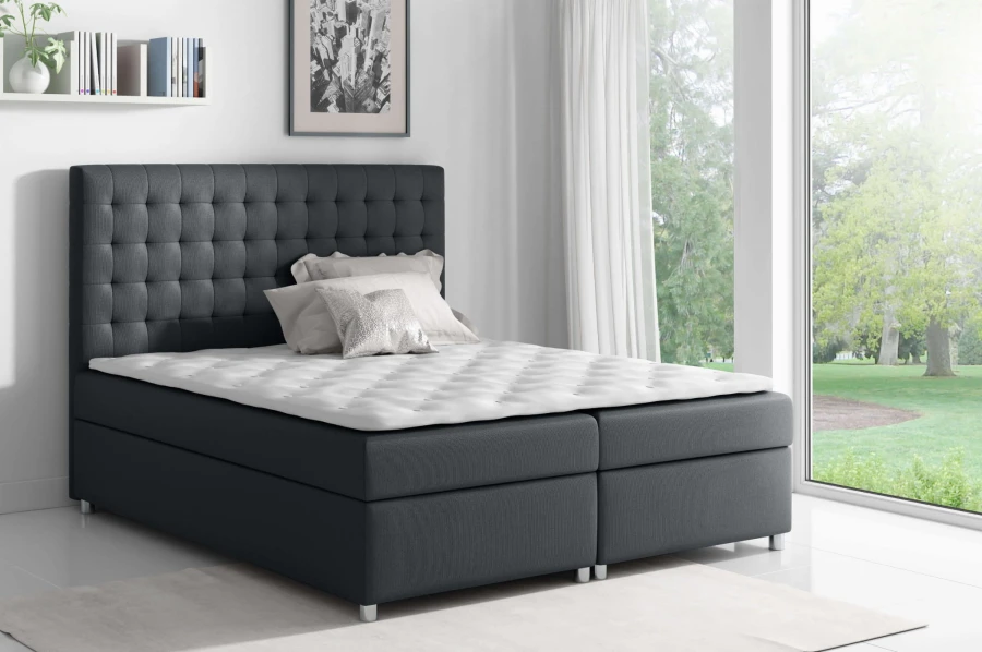 Modernes Boxspringbett in Anthrazit mit gestepptem Kopfteil für ein stilvolles Schlafzimmer.