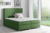 Grünes Boxspringbett mit hochwertigem Polsterbezug und gestepptem Kopfteil im modernen Schlafzimmer.