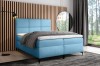 Hellblaues Boxspringbett mit abgestepptem Kopfteil in modernem Wohndesign.