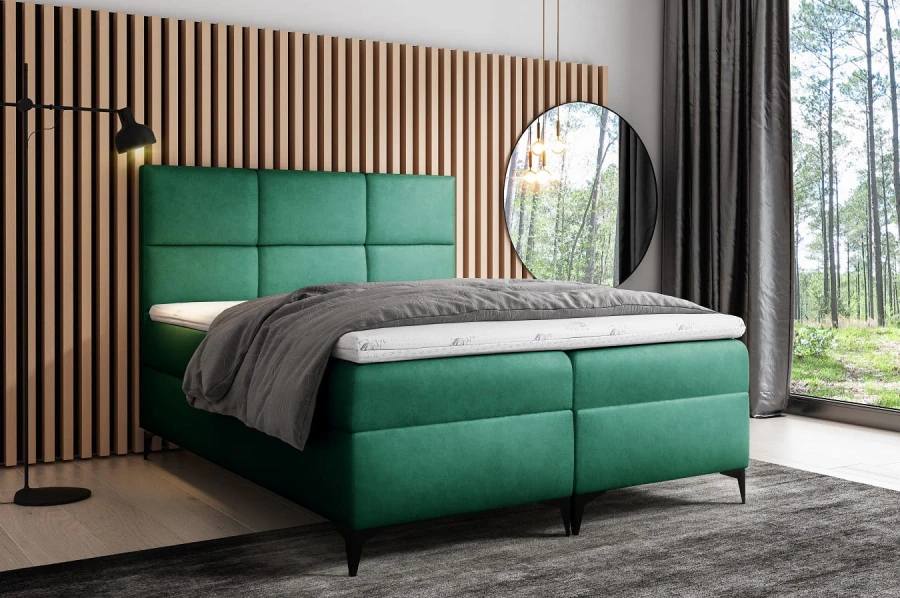 Grünes Boxspringbett mit gepolstertem Kopfteil im modernen Schlafzimmer mit Holz-Akzentwand.