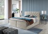 Beiges Boxspringbett mit gefächertem Kopfteil in einem modern eingerichteten Schlafzimmer.