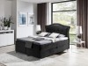 Schwarzes Boxspringbett mit elegantem Kopfteil für ein modernes Schlafzimmer