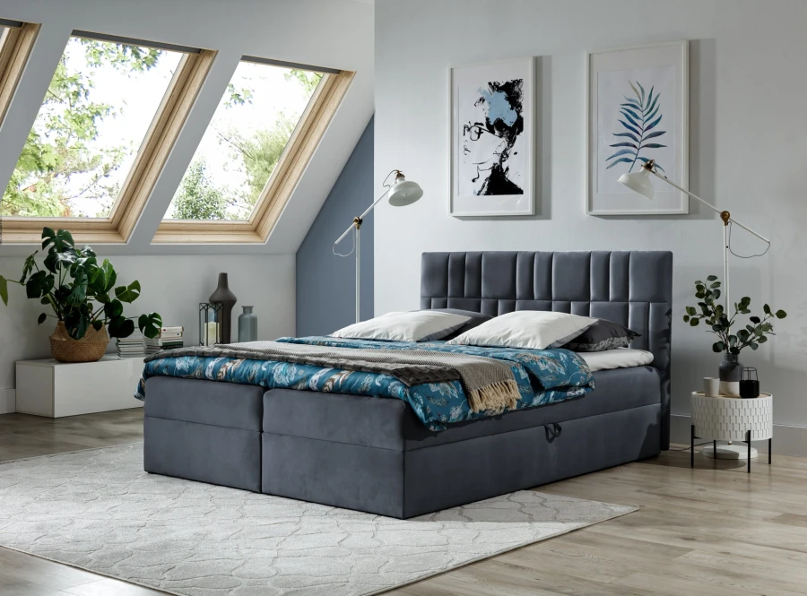 Graues Boxspringbett mit gestepptem Kopfteil in modernem Schlafzimmerambiente