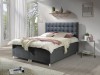 Dunkelgraues Boxspringbett mit dekorativer Knopfheftung am Kopfteil.