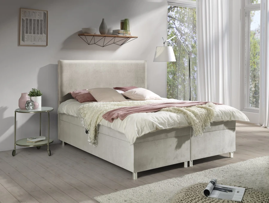 Beiges Polsterbett mit hohem Kopfteil und weißer Bettwäsche in modernem Schlafzimmer.
