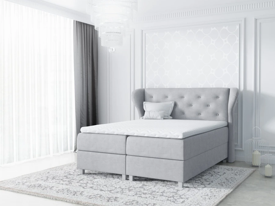 Elegantes graues Boxspringbett mit Knopfheftung und weißem Topper im Schlafzimmer.