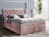 Rosa Boxspringbett mit hohem gestepptem Kopfteil für ein gemütliches Schlafzimmer