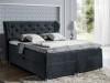 Dunkelblaues Boxspringbett mit gestepptem Kopfteil und eleganter Bettwäsche im modernen Schlafzimmer.