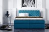 Elegantes blaues Boxspringbett mit gestepptem Kopfteil im modernen Schlafzimmer