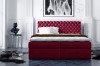 Weinrotes Boxspringbett mit Chesterfield-Kopfteil in elegantem Ambiente.