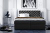 Dunkelgraues Boxspringbett mit gestepptem Polsterkopfteil in stilvollem Design.