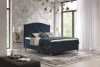 Dunkelblaues Boxspringbett mit Samtoptik und gestepptem Kopfteil in modernem Design.