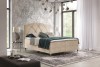 Modernes Boxspringbett in Beige mit gestepptem Kopfteil in einem hellen Schlafzimmer.