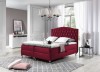 Rotes Boxspringbett mit Samtbezug und Knopfheftung am Kopfteil für elegantes Design.