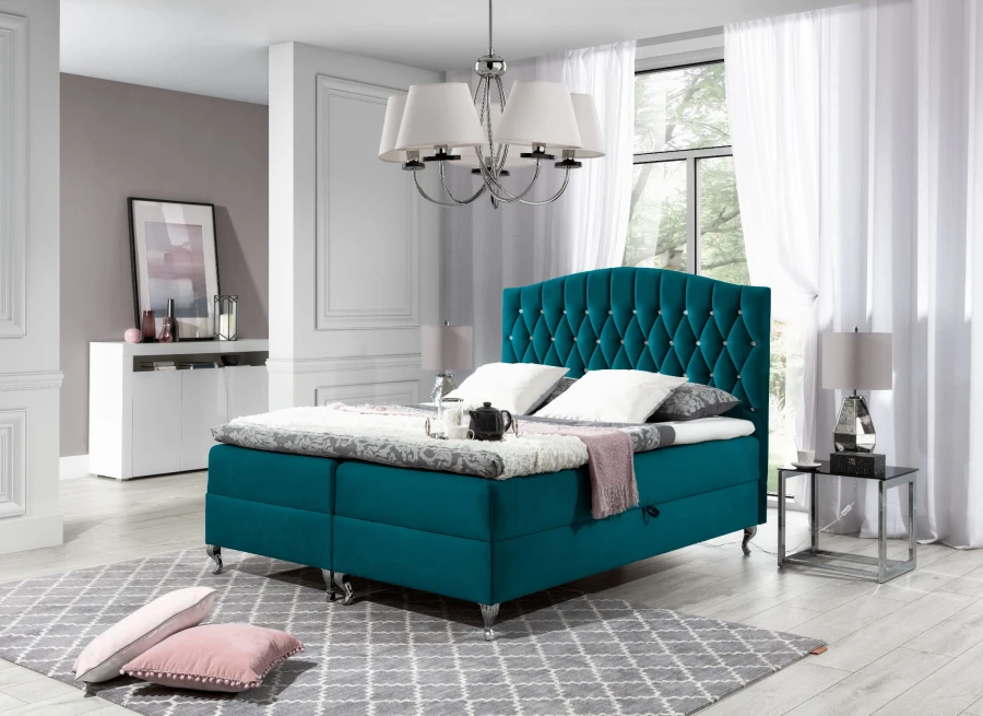Türkisfarbenes Boxspringbett mit dekorativer Knopfheftung und weichem Samtbezug.