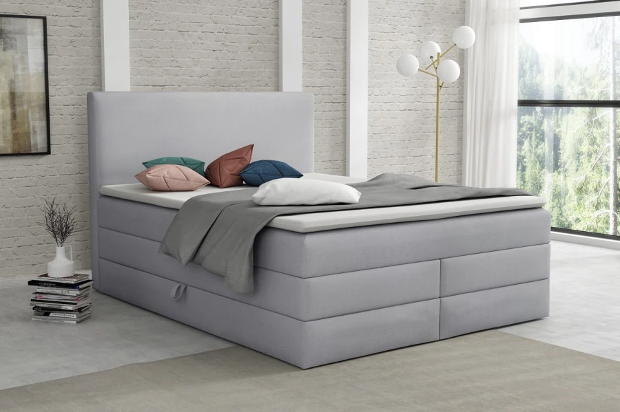 Elegantes hellgraues Boxspringbett für ein modernes Schlafzimmer-Ambiente
