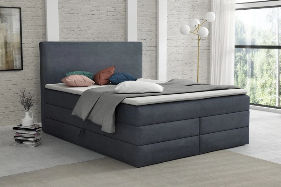 Hochwertiges Boxspringbett in Dunkelblau mit passendem Topper und modernem Polster-Kopfteil.