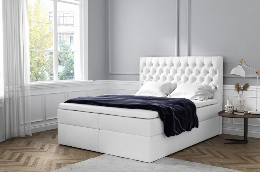 Weißes Boxspringbett mit luxuriöser Steppung für ein helles, stilvolles Schlafzimmer