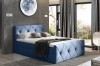 Blaues Boxspringbett mit moderner Rautensteppung an Kopf- und Fußteil.
