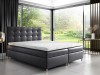 Anthrazitfarbenes Boxspringbett mit gestepptem Kopfteil in elegantem Design-Interieur.