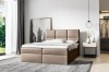 Elegantes beiges Boxspringbett in wohnlichem Schlafzimmer-Ambiente