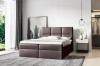 Braunes Boxspringbett mit gepolstertem Kopfteil in modernem Schlafzimmer-Design.