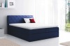 Dunkelblaues Boxspringbett mit Rauten-Steppung am Polsterkopfteil und gemütlichem Topper.