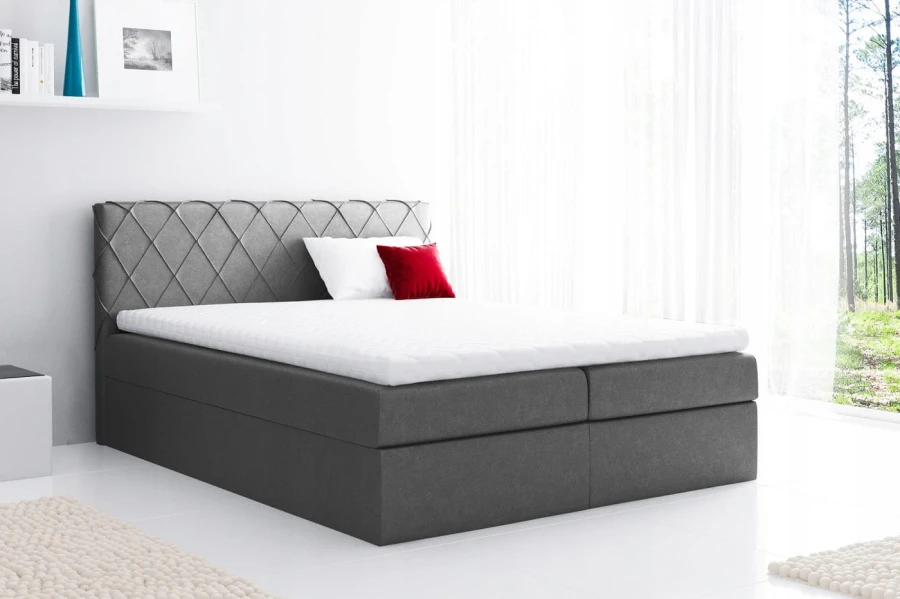 Anthrazitfarbenes Boxspringbett mit dekorativem Rautenmuster am Kopfteil und Topper.