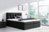 Elegantes schwarzes Boxspringbett mit hohem Kopfteil für ein modernes Ambiente.