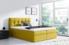 Modernes gelbes Boxspringbett in hellem Schlafzimmer mit gemütlicher Atmosphäre und großem Fenster.