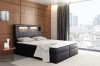 Schwarzes Boxspringbett mit LED-Beleuchtung im Kopfteil für ein modernes Schlafzimmer.